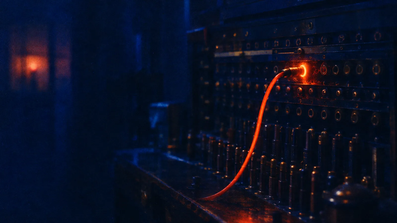 Grainy blue and orange film still of an old brass switchboard, one orange cable glowing as it plugs into a single lit socket