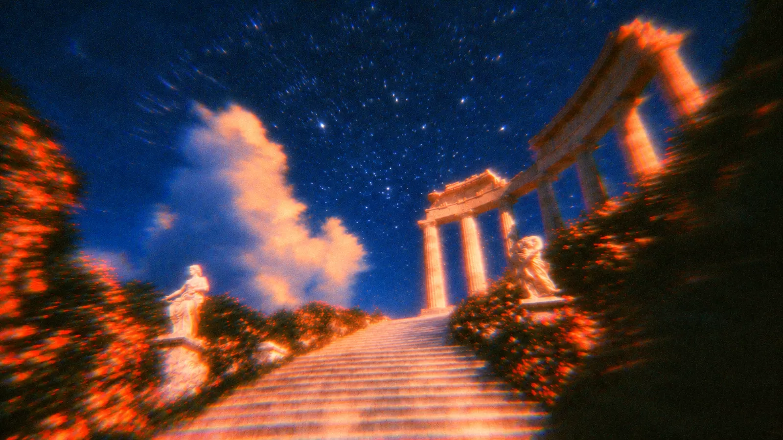 Grainy film still of a pale stone staircase climbing between orange-lit flowering hedges and statues toward a colonnade under a starry cobalt sky